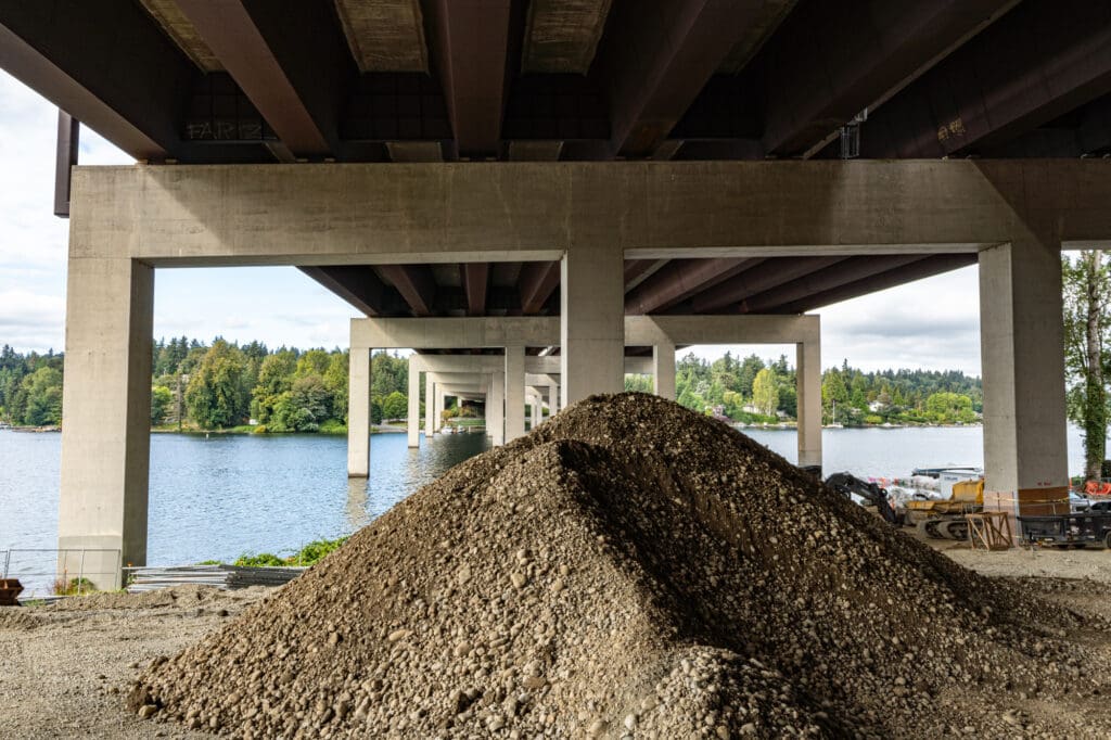 a large pile of streambed sediment rock is shown under the I-90 bridge on the Bellevue shoreline